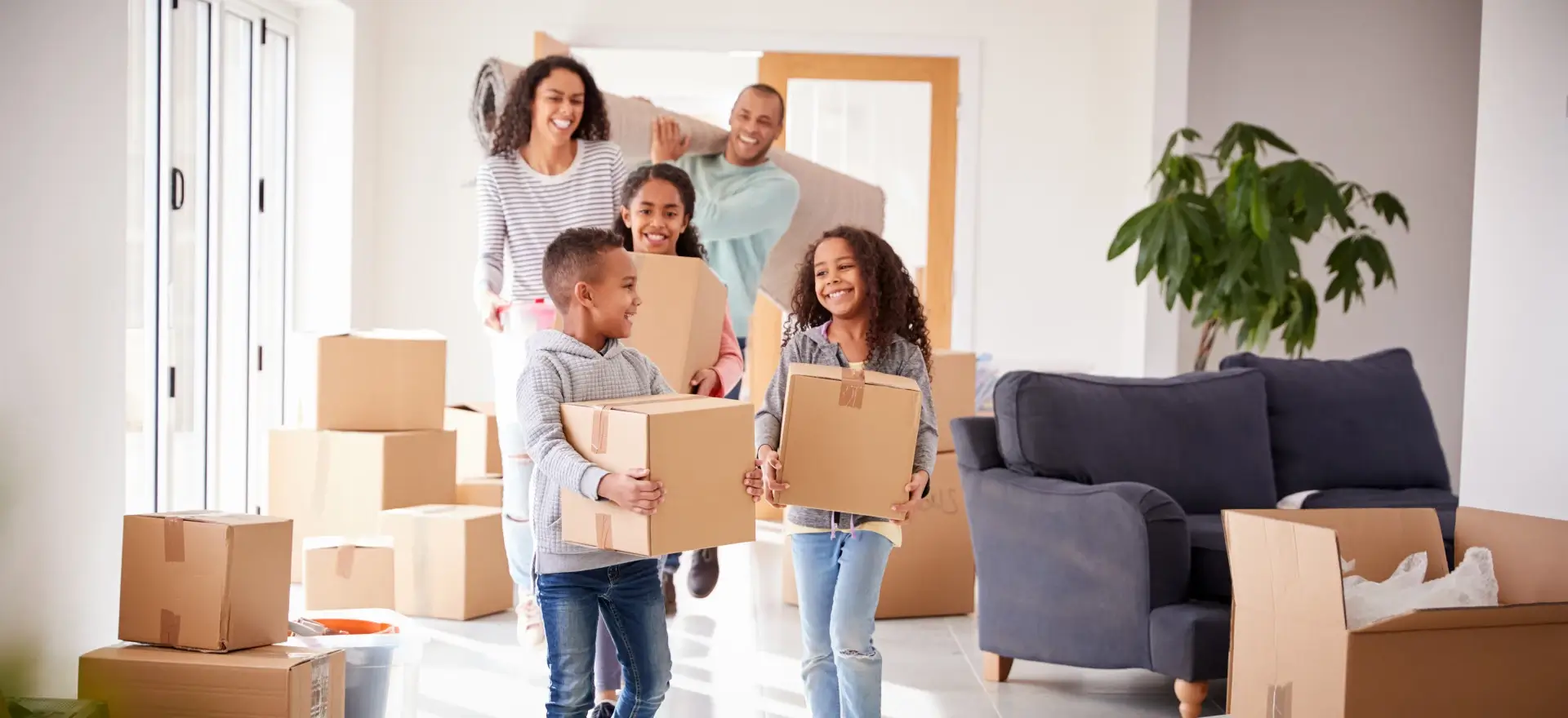 Happy family moving in to their new home thanks to Jhanti Mortgage Broker Corporation